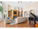 Bright living room showcasing a fireplace, built-in shelving, and a grand piano at 8050 Wacobee Dr., Myrtle Beach, SC 29579