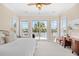 Spacious primary bedroom with a balcony overlooking serene waters, framed by large windows allowing ample natural light at 8050 Wacobee Dr., Myrtle Beach, SC 29579
