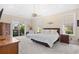 Main bedroom suite with tray ceilings, a ceiling fan, and sliding door access to the backyard at 8050 Wacobee Dr., Myrtle Beach, SC 29579