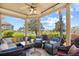 Relaxing screened-in porch with comfortable seating, offering scenic views of the lake and lush surroundings at 8050 Wacobee Dr., Myrtle Beach, SC 29579