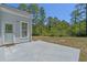 An exterior image showing the spacious concrete patio in the backyard, perfect for relaxing and entertaining at 832 Pembridge Ct., Myrtle Beach, SC 29579
