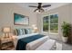 Staged guest bedroom featuring neutral decor, hardwood floors, natural lighting, and a ceiling fan at 832 Pembridge Ct., Myrtle Beach, SC 29579
