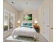 Staged primary bedroom with a plush rug, neutral decor, window view, and a chandelier at 832 Pembridge Ct., Myrtle Beach, SC 29579