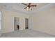 Spacious bedroom featuring tray ceiling, ceiling fan, and view into bathroom at 832 Pembridge Ct., Myrtle Beach, SC 29579