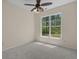 Bright, empty bedroom with a ceiling fan, neutral carpet, a large window and neutral walls at 832 Pembridge Ct., Myrtle Beach, SC 29579