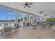 This photo features a community center lounge with tables and chairs overlooking the pool and scenic views at 832 Pembridge Ct., Myrtle Beach, SC 29579