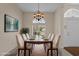 Staged dining room featuring neutral decor, a large table setting, chandelier, and a window with natural light at 832 Pembridge Ct., Myrtle Beach, SC 29579