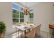 Dining area features a decorative chandelier, large windows, and a table set for six at 832 Pembridge Ct., Myrtle Beach, SC 29579