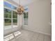 Bright dining area features a decorative chandelier and large windows offering natural light at 832 Pembridge Ct., Myrtle Beach, SC 29579