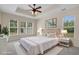 Staged bedroom features tray ceiling, ceiling fan, and multiple windows at 832 Pembridge Ct., Myrtle Beach, SC 29579