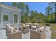 An exterior image of the patio with wicker furniture around a glass table for outdoor enjoyment at 832 Pembridge Ct., Myrtle Beach, SC 29579