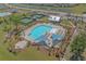 An aerial view of a community pool with a splash pad, covered seating, tennis courts, and a clubhouse at 832 Pembridge Ct., Myrtle Beach, SC 29579