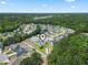 An aerial view showing the property's location within a community surrounded by natural greenery and a small lake at 853 Derbyshire Ct., Conway, SC 29526