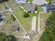 Aerial view of a spacious backyard with a shed and unique concrete pad, framed by a pristine white fence at 853 Derbyshire Ct., Conway, SC 29526