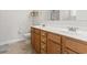 Bathroom featuring double sinks, wood cabinets, and tile floor at 853 Derbyshire Ct., Conway, SC 29526