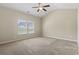 Spacious bedroom with neutral carpet, two windows, vaulted ceiling, and a ceiling fan at 853 Derbyshire Ct., Conway, SC 29526