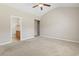 Bedroom showcasing neutral walls, carpet, a ceiling fan, and doorway to bathroom at 853 Derbyshire Ct., Conway, SC 29526