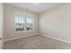 Bright bedroom with neutral walls, plush carpet, and a window providing natural light and neighborhood views at 853 Derbyshire Ct., Conway, SC 29526