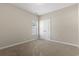 A cozy bedroom features neutral walls, a plush carpet, a window, and a double-door closet offering simple charm at 853 Derbyshire Ct., Conway, SC 29526