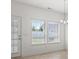 Eat-in dining area with tile floors, two windows, and a glass door to the backyard at 853 Derbyshire Ct., Conway, SC 29526