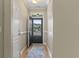 Bright foyer with wood floors, a blue rug, and natural light streaming in from the front door at 853 Derbyshire Ct., Conway, SC 29526