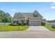 Charming home with well-maintained lawn, lush landscaping, and attached two-car garage at 853 Derbyshire Ct., Conway, SC 29526