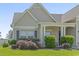 A close-up showing a well-manicured front yard featuring a charming front porch and well-maintained landscaping at 853 Derbyshire Ct., Conway, SC 29526