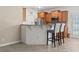 Kitchen featuring a breakfast bar, wood cabinets, stainless steel appliances, and tile flooring at 853 Derbyshire Ct., Conway, SC 29526