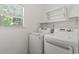 Laundry room with window, LG washer and dryer, and overhead shelving at 853 Derbyshire Ct., Conway, SC 29526
