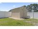 Back yard storage shed with decorative rock landscaping along the base at 853 Derbyshire Ct., Conway, SC 29526