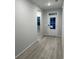 Inviting entryway with light wood flooring and a white front door with glass panels at 910 Inlet Keys St., Murrells Inlet, SC 29576