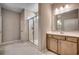 Modern bathroom showcasing a glass-enclosed shower, vanity with storage, and marble flooring at 912 Inlet Keys St., Murrells Inlet, SC 29576
