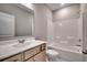 A full bathroom with a shower-tub combo, white vanity, and a neutral color scheme at 912 Inlet Keys St., Murrells Inlet, SC 29576