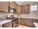 Close up of kitchen featuring stainless steel appliances, wooden cabinetry, and light countertops at 912 Inlet Keys St., Murrells Inlet, SC 29576