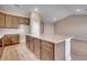 Kitchen island with light countertop and wooden cabinets, perfect for meal preparation at 912 Inlet Keys St., Murrells Inlet, SC 29576