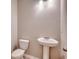 A simple powder room features a pedestal sink, toilet, and neutral wall color at 912 Inlet Keys St., Murrells Inlet, SC 29576