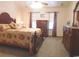 Comfortable bedroom featuring floral bedding, two dressers, and soft carpeting at 916 Charles St., North Myrtle Beach, SC 29582