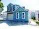 Charming two-story blue home with a garage, white picket fence and a delightful arched walkway at 916 Charles St., North Myrtle Beach, SC 29582