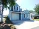 Charming two-story home with a garage and well-maintained landscaping at 916 Charles St., North Myrtle Beach, SC 29582