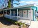 Charming pool house with teal trim, white doors, and a white picket fence; a delightful amenity for residents at 916 Charles St., North Myrtle Beach, SC 29582