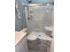 Modern bathroom with glass shower, white toilet, vanity, and gray tile flooring at 928 Strand Ave. Strand Ave., North Myrtle Beach, SC 29582