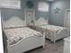 Bright bedroom with two beds, beach-themed decor, and soothing light blue walls at 928 Strand Ave. Strand Ave., North Myrtle Beach, SC 29582
