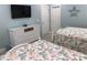 Bedroom featuring two beds, a television, and a white dresser, creating a cozy and functional space at 928 Strand Ave. Strand Ave., North Myrtle Beach, SC 29582