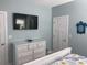 Bedroom with a dresser and TV, light walls, and nautical decorations in a serene setting at 928 Strand Ave. Strand Ave., North Myrtle Beach, SC 29582