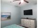Bedroom with a dresser and mounted TV, light walls, and a ceiling fan in a comfortable space at 928 Strand Ave. Strand Ave., North Myrtle Beach, SC 29582