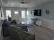 Comfortable living room with a plush sectional sofa, a ceiling fan, and a mounted television at 928 Strand Ave. Strand Ave., North Myrtle Beach, SC 29582