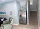 View of the living room featuring a refrigerator and stairs, with cool blue walls and modern decor at 928 Strand Ave. Strand Ave., North Myrtle Beach, SC 29582