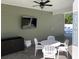 A view of the outdoor patio area with a TV, ceiling fan, and comfortable seating. A great entertainment space! at 928 Strand Ave. Strand Ave., North Myrtle Beach, SC 29582