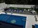 Aerial view of the in-ground pool, lounge chairs, and outdoor game area, all surrounded by a privacy fence at 928 Strand Ave. Strand Ave., North Myrtle Beach, SC 29582