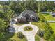A high-angle view of a brick home, circle driveway and landscaped front yard at 9449 Freewoods Rd., Myrtle Beach, SC 29588